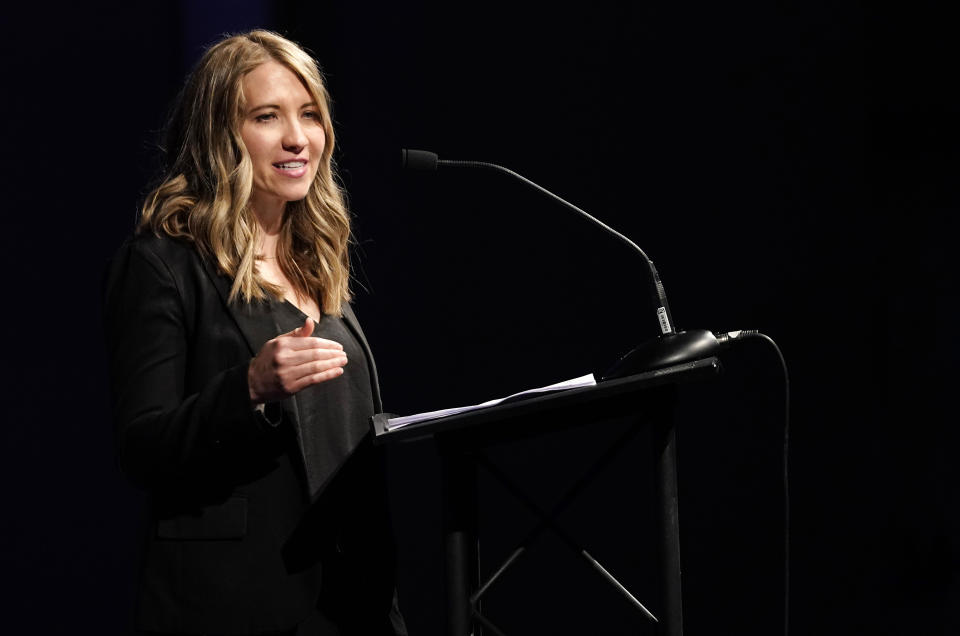 Crystal Woodman-Miller, who was a student at Columbine High School during the massacre nearly 20 years earlier, speaks during a faith-based memorial service for the victims at a community church, Thursday, April 18, 2019, in Littleton, Colo. (Rick Wilking/Pool Photo via AP)