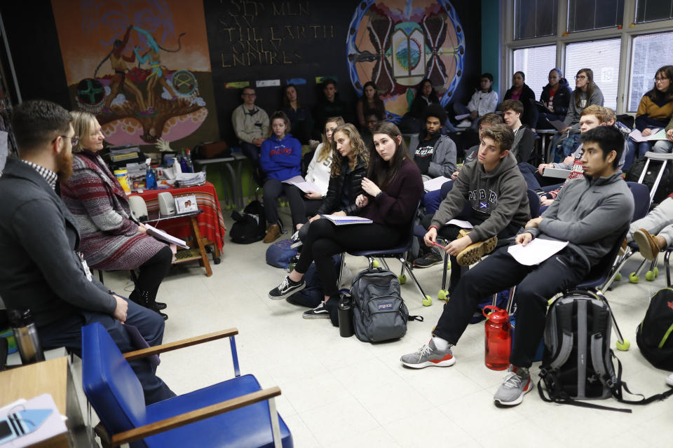 In this Thursday, Jan. 24, 2019, photo students listen as social studies teachers Judi Galasso and Jonathan Duffy lead the introductory class of their American Thought and Political Radicalism course at Thomas Worthington High School, in Worthington, Ohio. (AP Photo/John Minchillo)