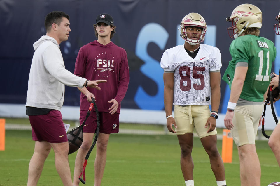 Florida State quarterback Brock Glenn (11) performs drills with tight end Markeston Douglas (85) in preparation for the Orange Bowl NCAA college football game, Tuesday, Dec. 26, 2023, in Davie, Fla. Florida State will play Georgia in the Orange Bowl Dec. 30 at Hard Rock Stadium in Miami Gardens. (AP Photo/Lynne Sladky)