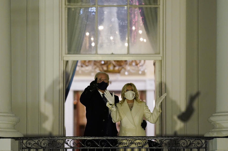 President Joe Biden and first lady Jill Biden watch fireworks light up the sky from the White House, Wednesday, Jan. 20, 2021, in Washington. (AP Photo/Evan Vucci)