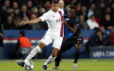 Paris Saint Germain's Kylian Mbappe (L) and Brugge?s Odilon Kossounou in action during the UEFA Champions League Group A soccer match between Paris Saint Germain and Club Brugge - Credit: Rex