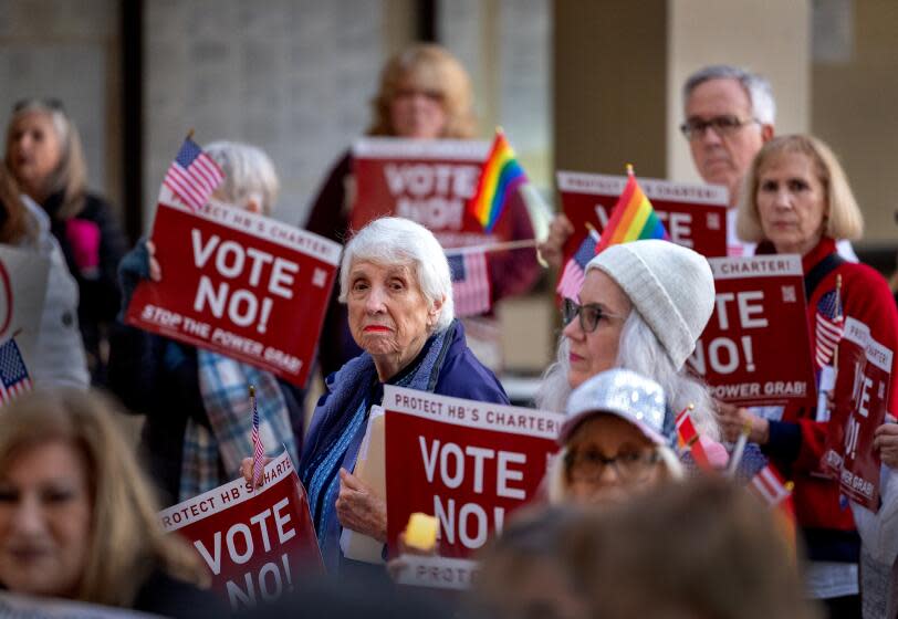 Huntington Beach, CA - January 16: Former Huntington Beach Mayor Shirley Dettloff, center, joins Protect Huntington Beach, a group of concerned residents of Huntington Beach who want to increase residents' awareness of proposed charter changes during a protest outside Huntington Beach City Hall Tuesday before council meeting Tuesday, Jan. 16, 2024. (Allen J. Schaben / Los Angeles Times)