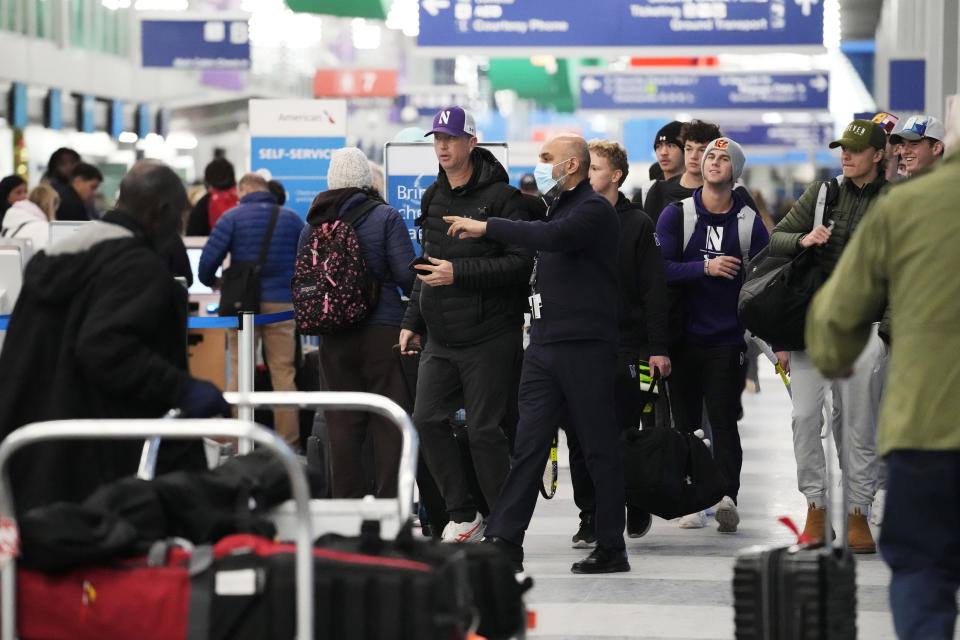 Travelers walk through Terminal 3 at the O'Hare International Airport in Chicago, Sunday, Jan. 14, 2024. Over 70 flight cancellations at Chicago airports Sunday. (AP Photo/Nam Y. Huh)