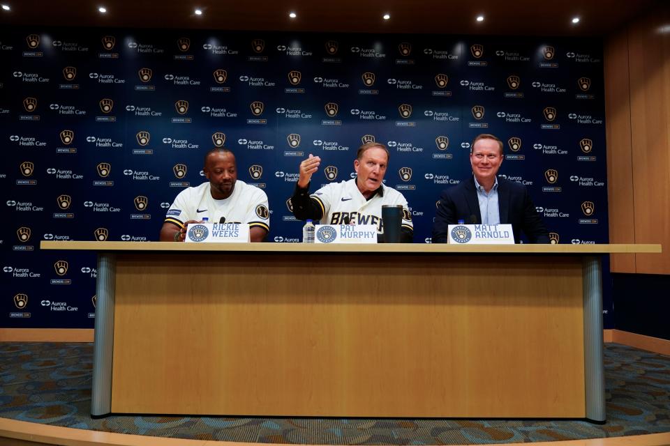 Pat Murphy is flanked by associate manager Ricky Weeks and general manager Matt Arnold at a news conference where he was named Milwaukee Brewers manager Thursday, Nov. 16, 2023, in Milwaukee. (AP Photo/Morry Gash)