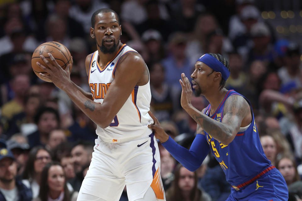 DENVER, COLORADO - APRIL 29: Kevin Durant #35 of the Phoenix Suns is guarded by Kentavious Caldwell-Pope #5 of the Denver Nuggets in the first quarter at Ball Arena on April 29, 2023 in Denver, Colorado. NOTE TO USER: User expressly acknowledges and agrees that, by downloading and/or using this photograph, User is consenting to the terms and conditions of the Getty Images License Agreement. (Photo by Matthew Stockman/Getty Images)