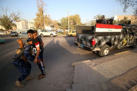 Iraqi security forces check the protesters near the main provincial government building Basra, Iraq July 14, 2018. Picture taken July 14, 2018. REUTERS/Essam al-Sudani