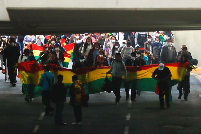 Opponents of Bolivia's President Evo Morales hold Bolivian flags during a protest, in La Paz