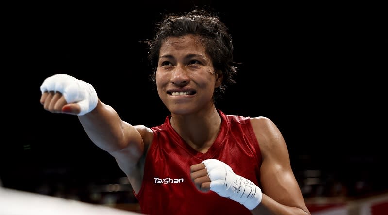 TOKYO, JAPAN - JULY 30: Lovlina Borgohain (red) of Team India celebrates victory over Nien Chin Chen of Team Chinese Taipei during the Women's Welter (64-69kg) quarter final on day seven of the Tokyo 2020 Olympic Games at Kokugikan Arena on July 30, 2021 in Tokyo, Japan. (Photo by Buda Mendes/Getty Images)