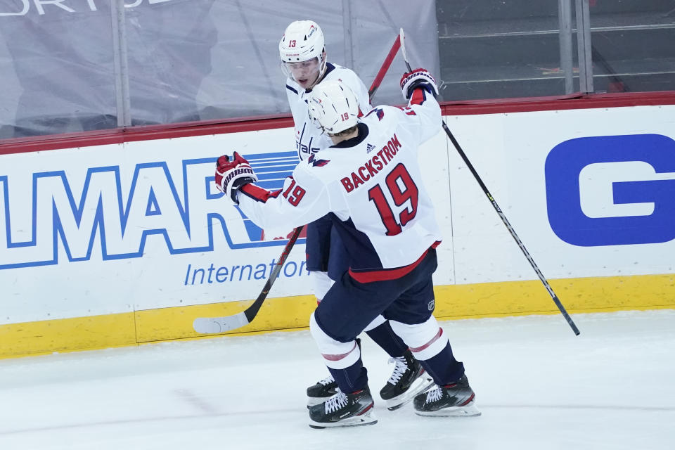 Washington Capitals left wing Jakub Vrana (13) celebrates after scoring a goal with center Nicklas Backstrom (19) during the third period of an NHL hockey game against the New Jersey Devils, Saturday, Feb. 27, 2021, in Newark, N.J. (AP Photo/Mary Altaffer)