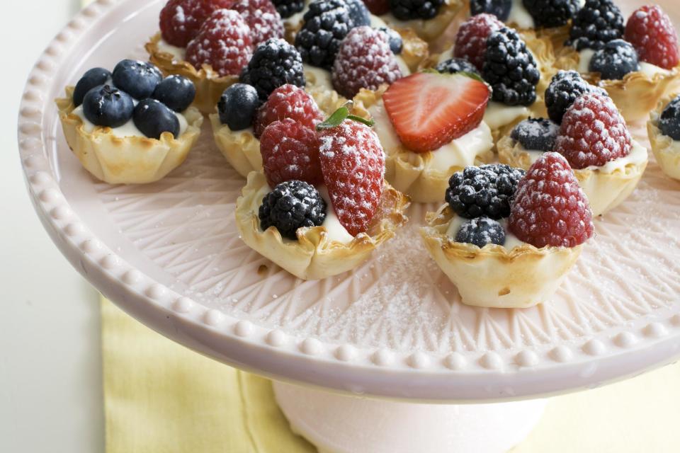 In this image taken on March 4, 2013, creamy lemon-berry tartlets are shown served on a dessert stand in Concord, N.H. (AP Photo/Matthew Mead)