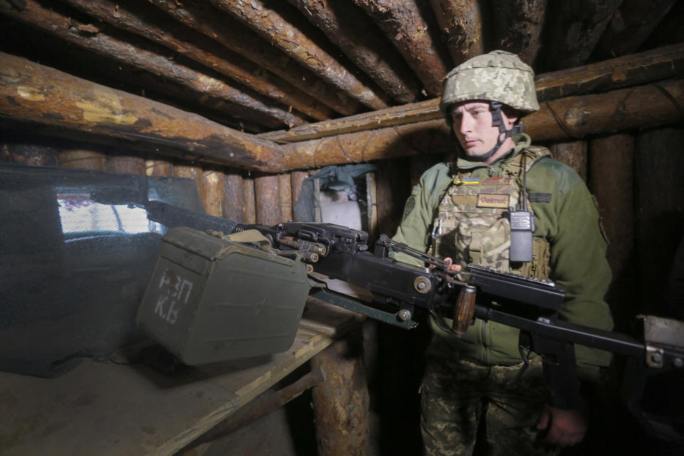 A Ukrainian soldier is seen at fighting positions on the line of separation from pro-Russian rebels near Luhansk, Ukraine, Friday, April 16, 2021. Growing cease-fire violations and a massive Russian military buildup are causing tensions to rise in the conflict in eastern Ukraine, where more than 14,000 people have died in seven years of fighting between forces from Kyiv and separatists loyal to Moscow. (AP Photo/Efrem Lukatsky)