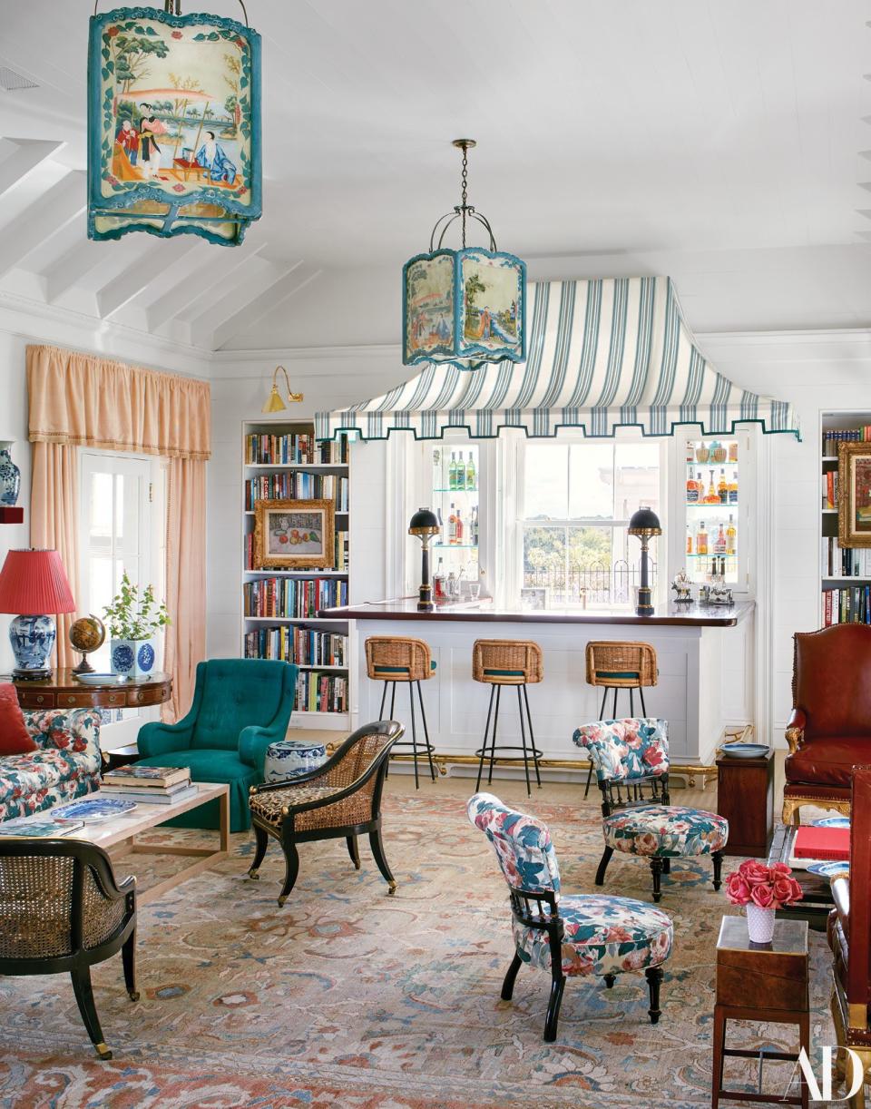 The living room features a bar tented with a Brunschwig & Fils stripe. Custom painted lanterns from John Rosselli Antiques.