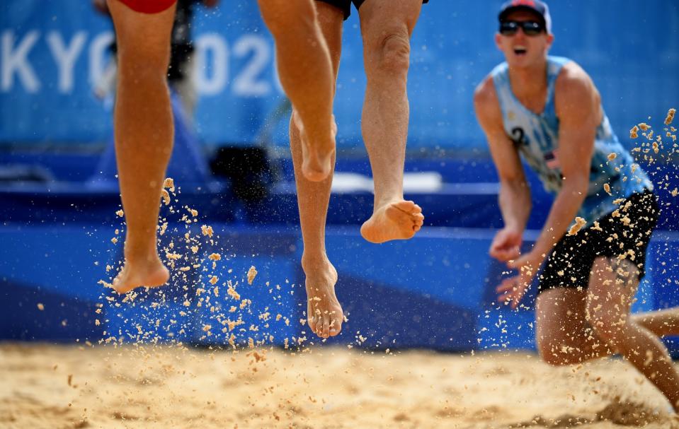 The United States' Tri Bourne plays defense against Switzerland in beach volleyball.