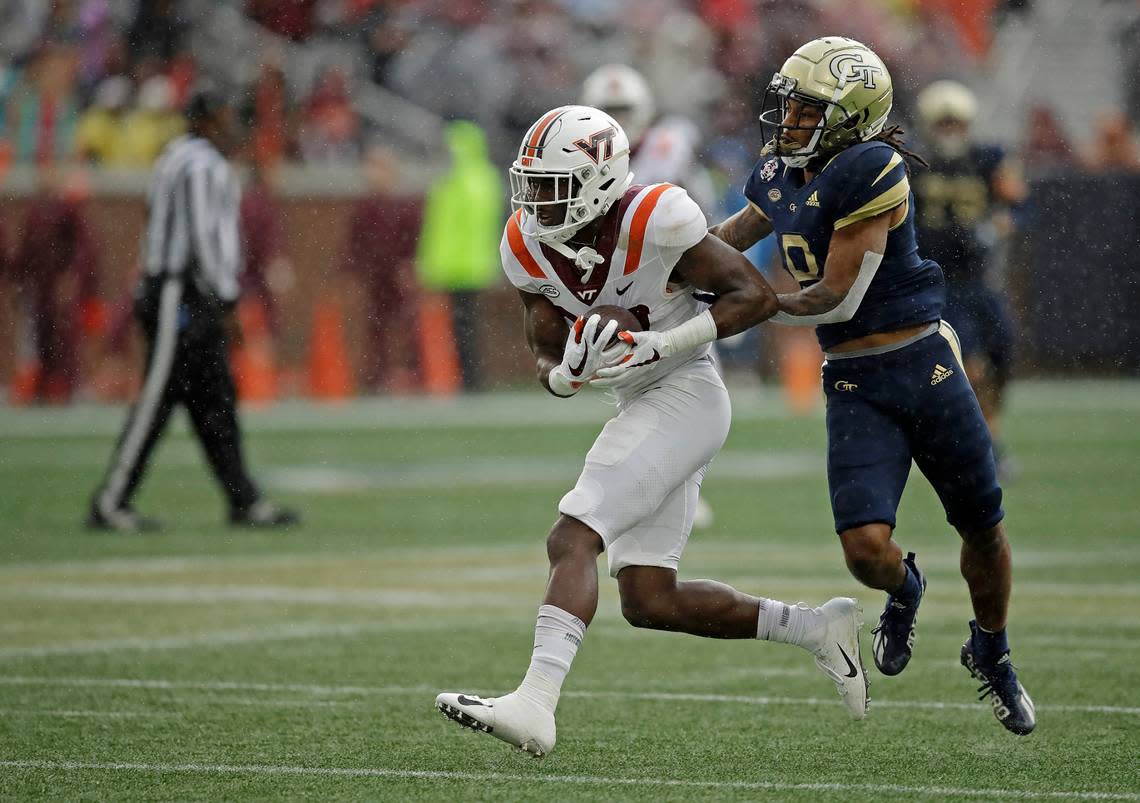 Virginia Tech defensive back Armani Chatman, left, intercepts a pass intended for Georgia Tech wide receiver Nate McCollum (8) during the fourth quarter of an NCAA college football game Saturday, Oct. 30, 2021, in Atlanta. (AP Photo/Ben Margot)
