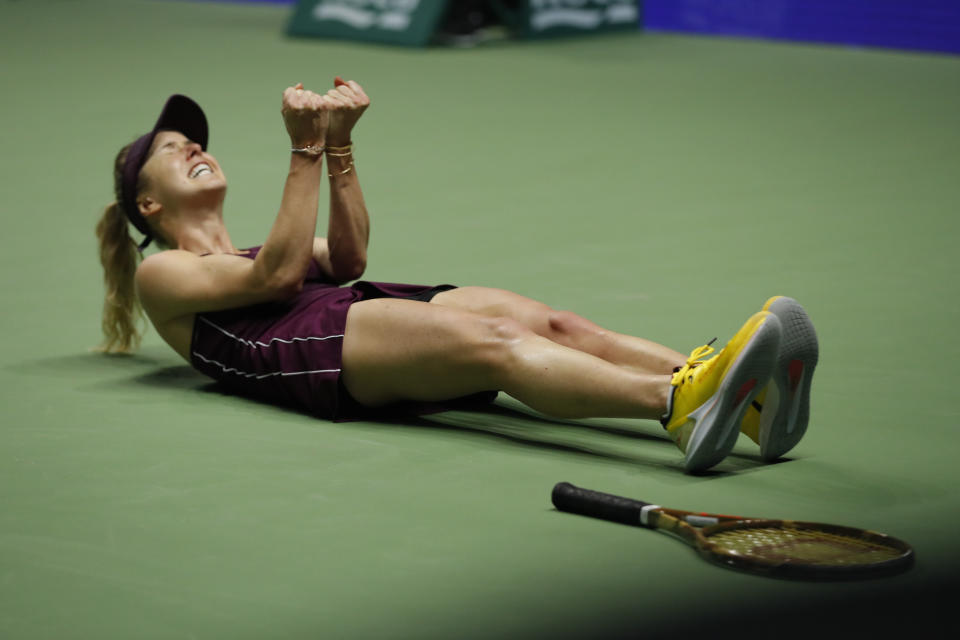 Elina Svitolina falls to the ground in delight after winning her singles final against Sloane Stephens at the WTA Finals Singapore. (PHOTO: AP/Vincent Thian)