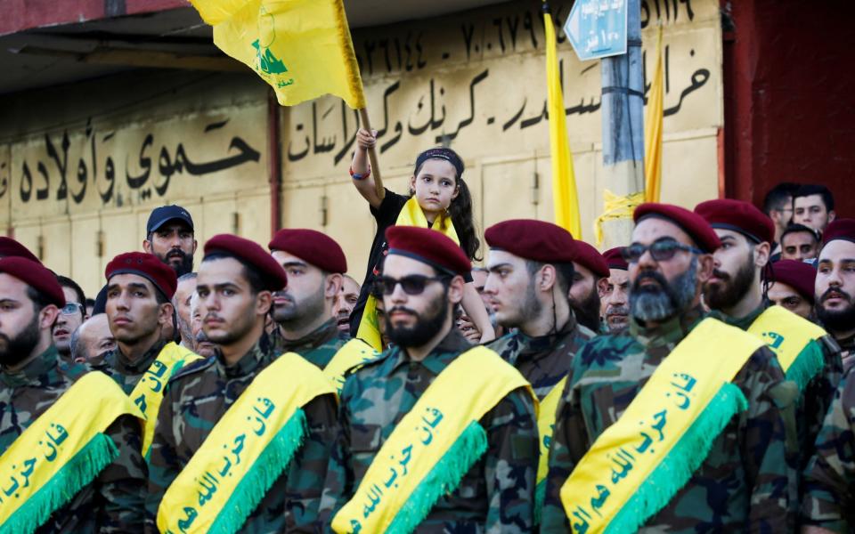 Hezbollah members and supporters gather for a funeral for those killed in an Israeli attack