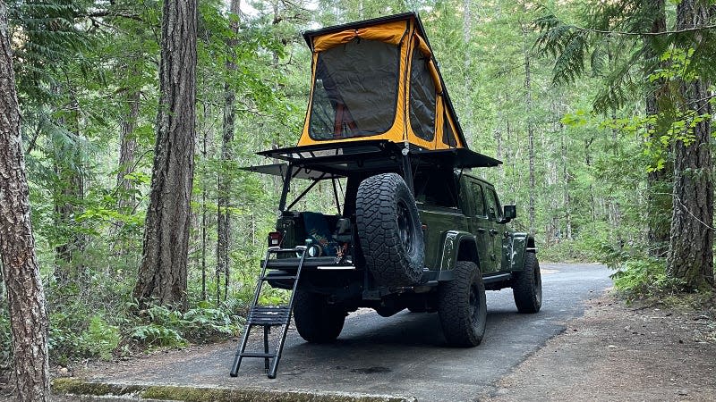 A photo of the GFC camper set up at a camp site. 