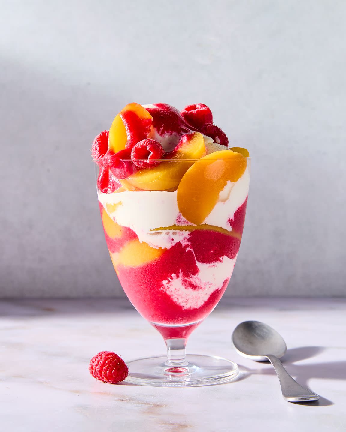 vanilla ice cream topped with peaches and raspberries
