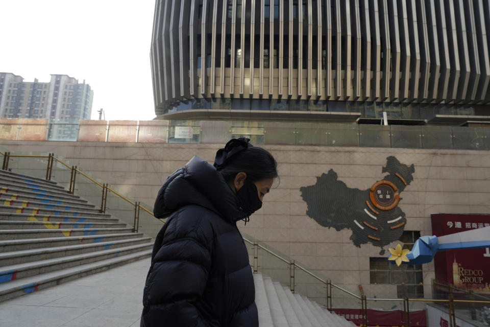 A woman walks through a partially shuttered Evergrande commercial complex in Beijing, Monday, Jan. 29, 2024. Chinese property developer China Evergrande Group on Monday was ordered to liquidate by a Hong Kong court, after the firm was unable to reach a restructuring deal with creditors. (AP Photo/Ng Han Guan)