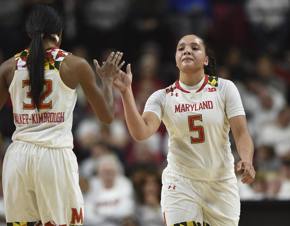 Maryland's Destiny Slocum, right, and Shatori Walker-Kimbrough high-five after Maryland scored against Connecticut late in the second half of an NCAA college basketball game, Thursday, Dec. 29, 2016 in College Park, Md. Connecticut won 87-81. (AP Photo/Gail Burton)