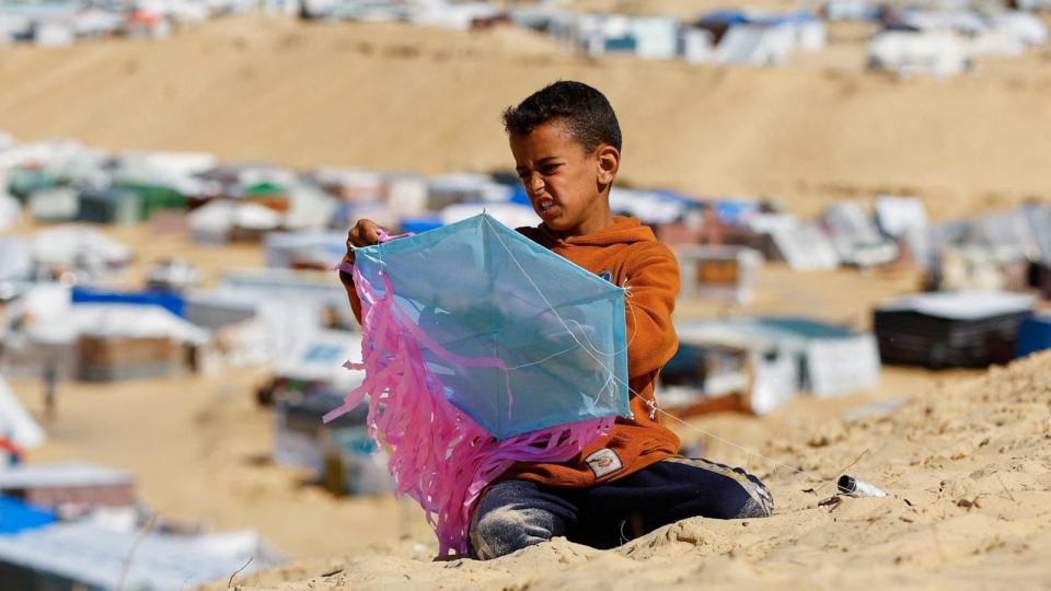 PHOTO: A displaced Palestinian boy prepares a kite amid the ongoing conflict between Israel and Palestinian Islamist group Hamas, at the border with Egypt, in Rafah, in the southern Gaza Strip, Feb. 8, 2024.  (Ibraheem Abu Mustafa/Reuters)