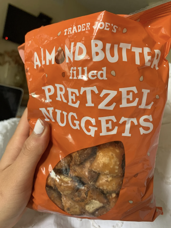 Hand holding a bag of Trader Joe's Almond Butter Filled Pretzel Nuggets