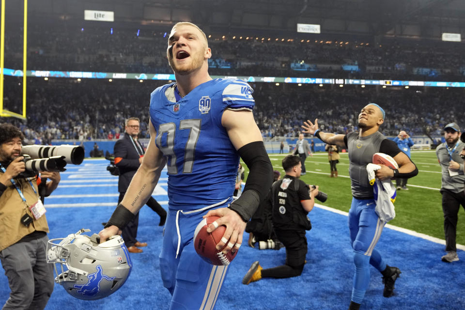 Detroit Lions defensive end Aidan Hutchinson (97) and wide receiver Amon-Ra St. Brown walks off the field after an NFL wild-card playoff football game against the Los Angeles Rams, Sunday, Jan. 14, 2024, in Detroit. (AP Photo/Paul Sancya)