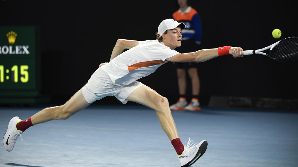 Jannik Sinner of Italy plays a backhand return to Stefanos Tsitsipas of Greece during their quarterfinal match at the Australian Open tennis championships in Melbourne, Australia, Wednesday, Jan. 26, 2022. (AP Photo/Andy Brownbill)