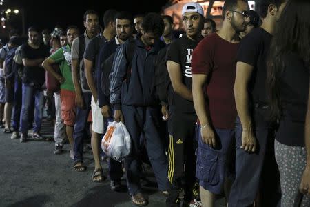 Syrian refugees line up before boarding the passenger ship "Eleftherios Venizelos" at the port on the Greek island of Kos, August 15, 2015. REUTERS/Alkis Konstantinidis