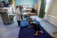 A child who suffers from cancer lies on a bed at the Children's Hospital for Cancer Diseases in Basra