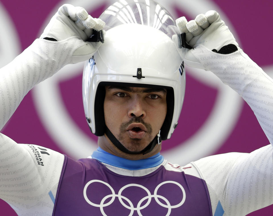 FILE - In this Feb. 6, 2014 file photo, Shiva Keshavan of India prepares to start his run during a training session for the men's singles luge at the 2014 Winter Olympics in Krasnaya Polyana, Russia. Keshavan competed under the Olympic flag because India's Olympic body had been suspended by the IOC in 2012 over a corruption scandal. On Tuesday, Feb. 11, 2014, the IOC executive board reinstated the Indian Olympic body after it held a weekend ballot that complied with ethics rules barring corruption-tainted officials from running for election. (AP Photo/Natacha Pisarenko, File)