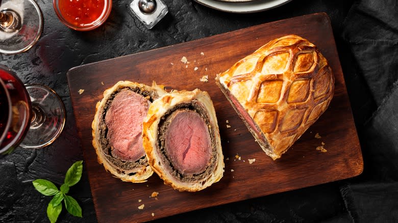 beef wellington slices on a chopping board