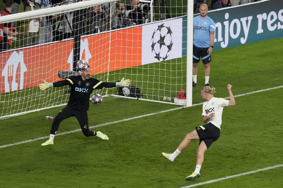 Manchester City's Erling Haaland scores past Scott Carson during a training session at the Ataturk Olympic Stadium in Istanbul, Turkey, Friday, June 9, 2023. Manchester City and Inter Milan are making their final preparations ahead of their clash in the Champions League final on Saturday night. (AP Photo/Thanassis Stavrakis)