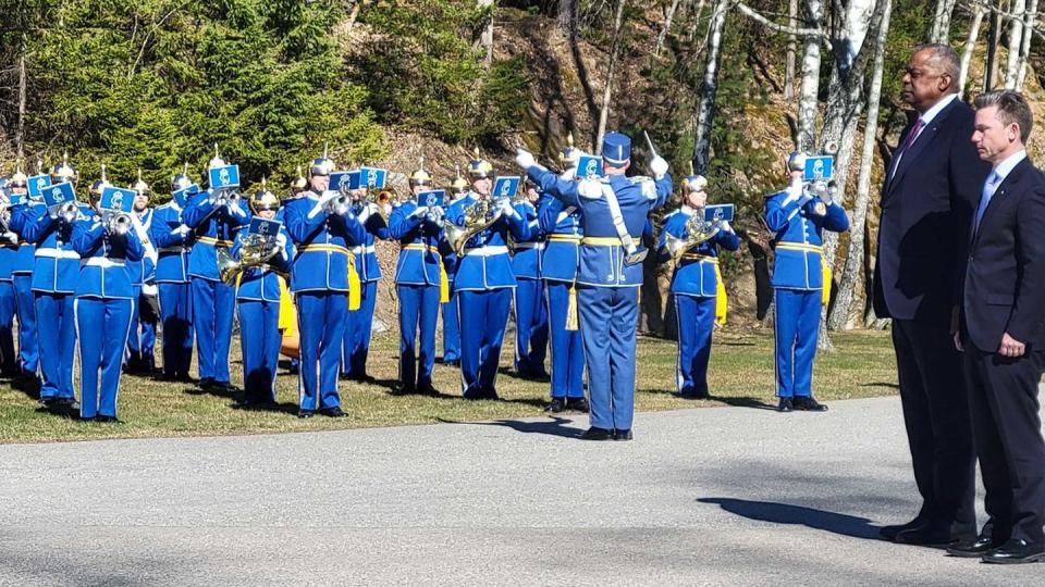 U.S. Defense Secretary Lloyd Austin and Swedish Defense Minister Pål Jonson listen to their national anthems at a welcome ceremony for Austin at Muskö Naval Base, Sweden, April 19. (Rachel Cohen/Staff)