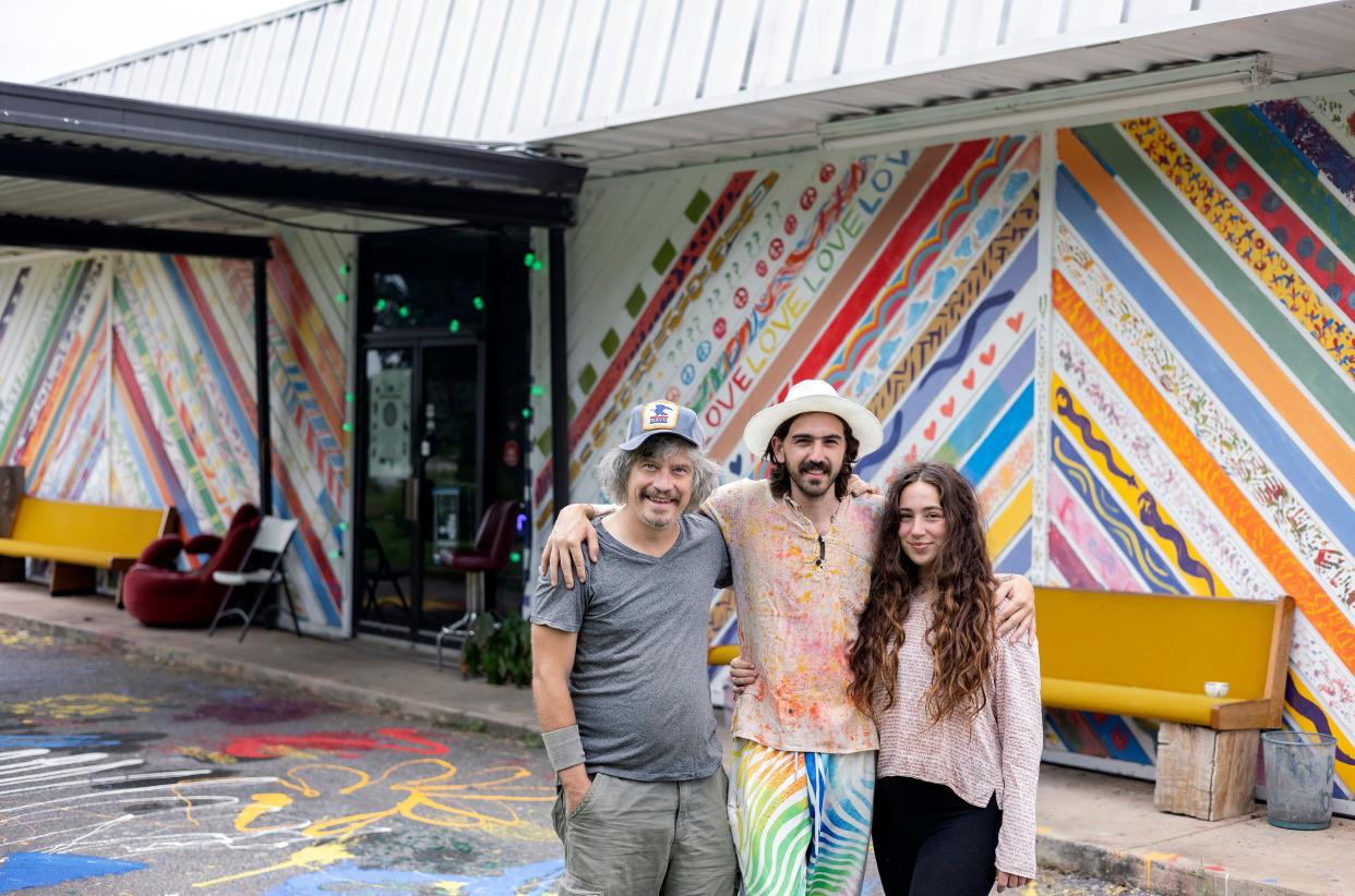 Sean T. Conlon, left, Nicholas Bradfield and Victoria Austin stand outside Rabbit Hole Studios, a music and arts community center where artists of all backgrounds can gather to rehearse, record and hold events, on Monday, Aug. 1, 2022 in Athens.