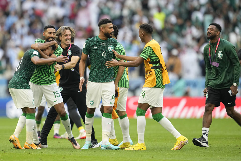 Saudi Arabia's head coach Herve Renard, third from the left, celebrates with players at the end of the World Cup group C soccer match between Argentina and Saudi Arabia at the Lusail Stadium in Lusail, Qatar, Tuesday, Nov. 22, 2022. (AP Photo/Ebrahim Noroozi)