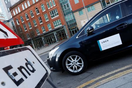 An Uber taxi is driven away from New Street Railway Station in Birmingham, Britain February 5, 2018. REUTERS/Darren Staples/Files