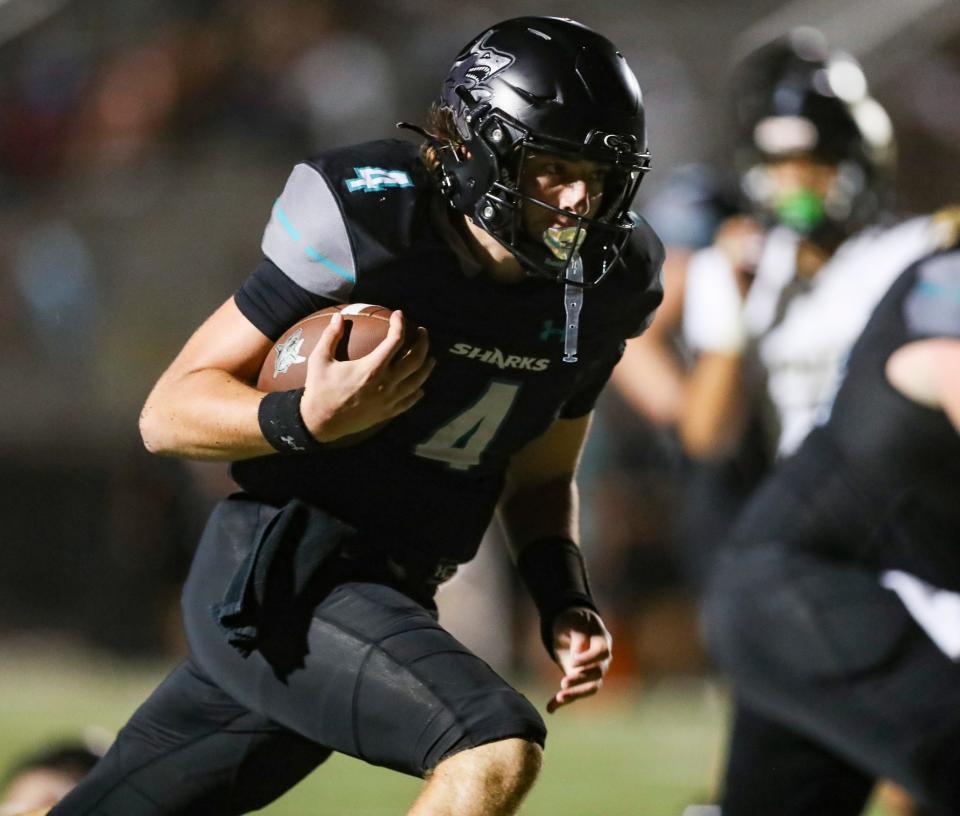 Gulf Coast Sharks quarterback Jace Seyler (4) runs the ball for a touchdown during the fourth quarter of a game at Gulf Coast High School in Naples on Friday, Sept. 22, 2023.