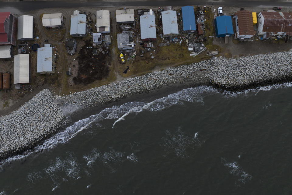 Small waves crash into reinforced seawalls in Shishmaref, Alaska, Tuesday, Oct. 4, 2022. Rising sea levels, flooding, increased erosion and loss of protective sea ice and land have led residents of this island community to vote twice to relocate. But more than six years after the last vote, Shishmaref remains in the same place because the relocation is too costly. (AP Photo/Jae C. Hong)