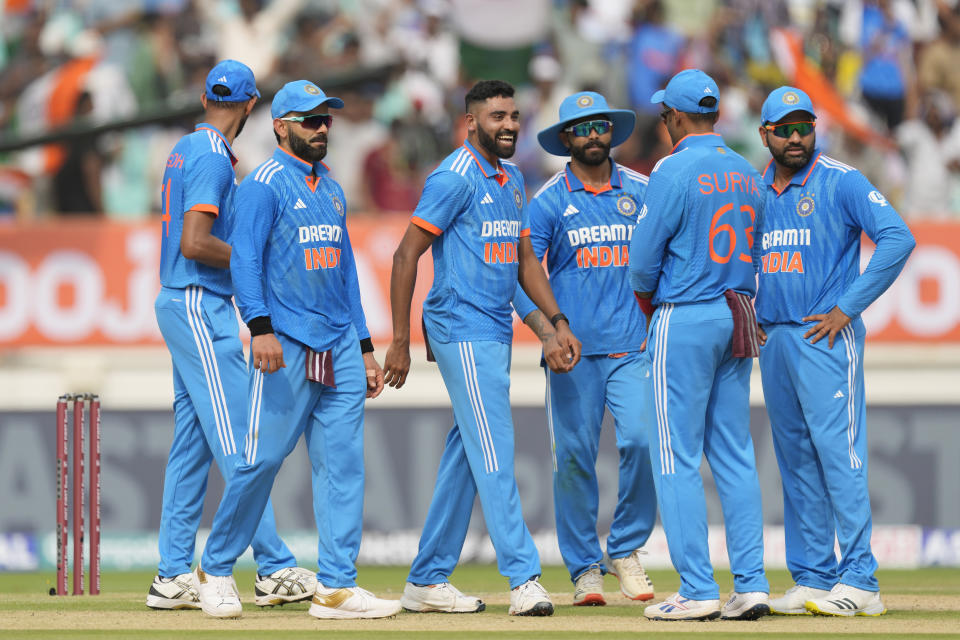 India's Mohammed Siraj, center, celebrates the wicket of Australia's Steve Smith during the third one day international cricket match between Australia and India in Rajkot, India, Wednesday, Sept. 27, 2023. (AP Photo/Ajit Solanki)