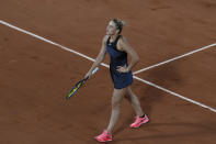 Ukraine's Marta Kostyuk reacts after missing a shot as she plays against Poland's Iga Swiatek during their fourth round match on day 9, of the French Open tennis tournament at Roland Garros in Paris, France, Monday, June 7, 2021. (AP Photo/Christophe Ena)