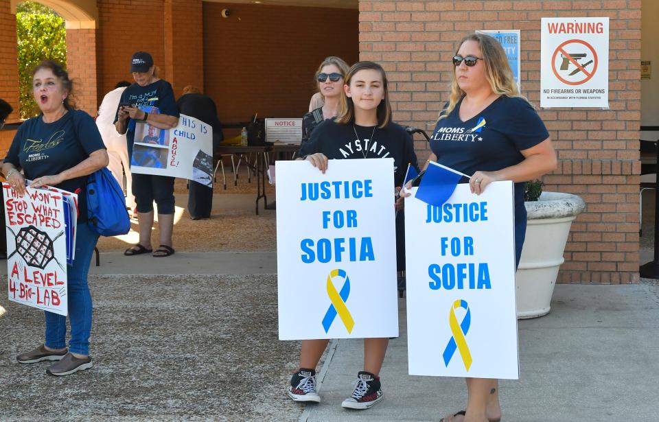 Demonstrators call attention to a case of Sofia, a 7-year-old student with Down syndrome who came home from school with a mask tied to her face, at the Oct. 26, 2021, Brevard County School Board meeting in this file photo.