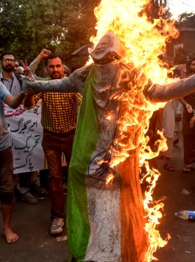 Pakistani protesters burn an effigy of Indian Prime Minister Narendra Modi during a protest in the Pakistani city of Lahore