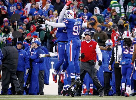 Jan 3, 2016; Orchard Park, NY, USA; Buffalo Bills outside linebacker Manny Lawson (91) celebrates his interception as Buffalo Bills head coach Rex Ryan looks on during the second half against the New York Jets at Ralph Wilson Stadium. Mandatory Credit: Kevin Hoffman-USA TODAY Sports