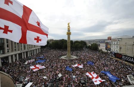 People gather for a rally to protest against Russian military actions and its backing for the country's two separatist regions Abkhazia and South Ossetia in Tbilisi in this September 1, 2008 file photo. Undeterred by the conflict triggered by Ukraine's swing towards Europe, the former Soviet republics of Moldova and Georgia will sign a trade and political pact with the European Union this month with Russia warning both countries against the move, reported June 10, 2014. REUTERS/Irakli Gedenidze/Pool/Files