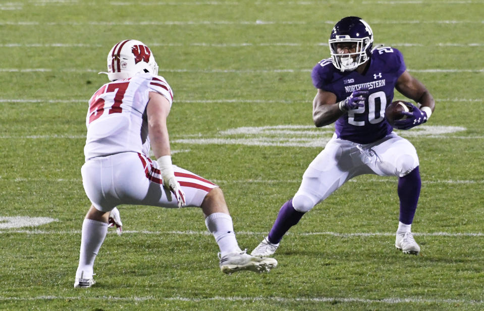 Nov. 21, 2020; Evanston, Illinois; Wisconsin Badgers linebacker Jack Sanborn (57) defends Northwestern Wildcats running back Cam Porter (20) during the second half at Ryan Field. David Banks-USA TODAY Sports