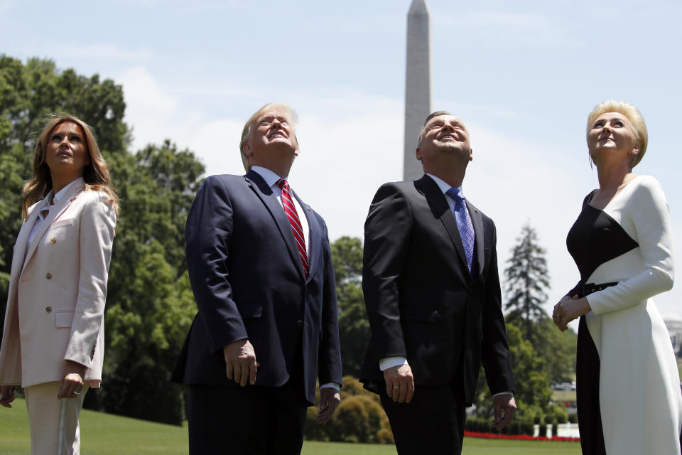 President Donald Trump, first lady Melania Trump, Polish President Andrzej Duda, and his wife Agata Kornhauser-Duda watch a flyover of a F-35 Lightning II jet at the White House, Wednesday, June 12, 2019, in Washington. (AP Photo/Alex Brandon)