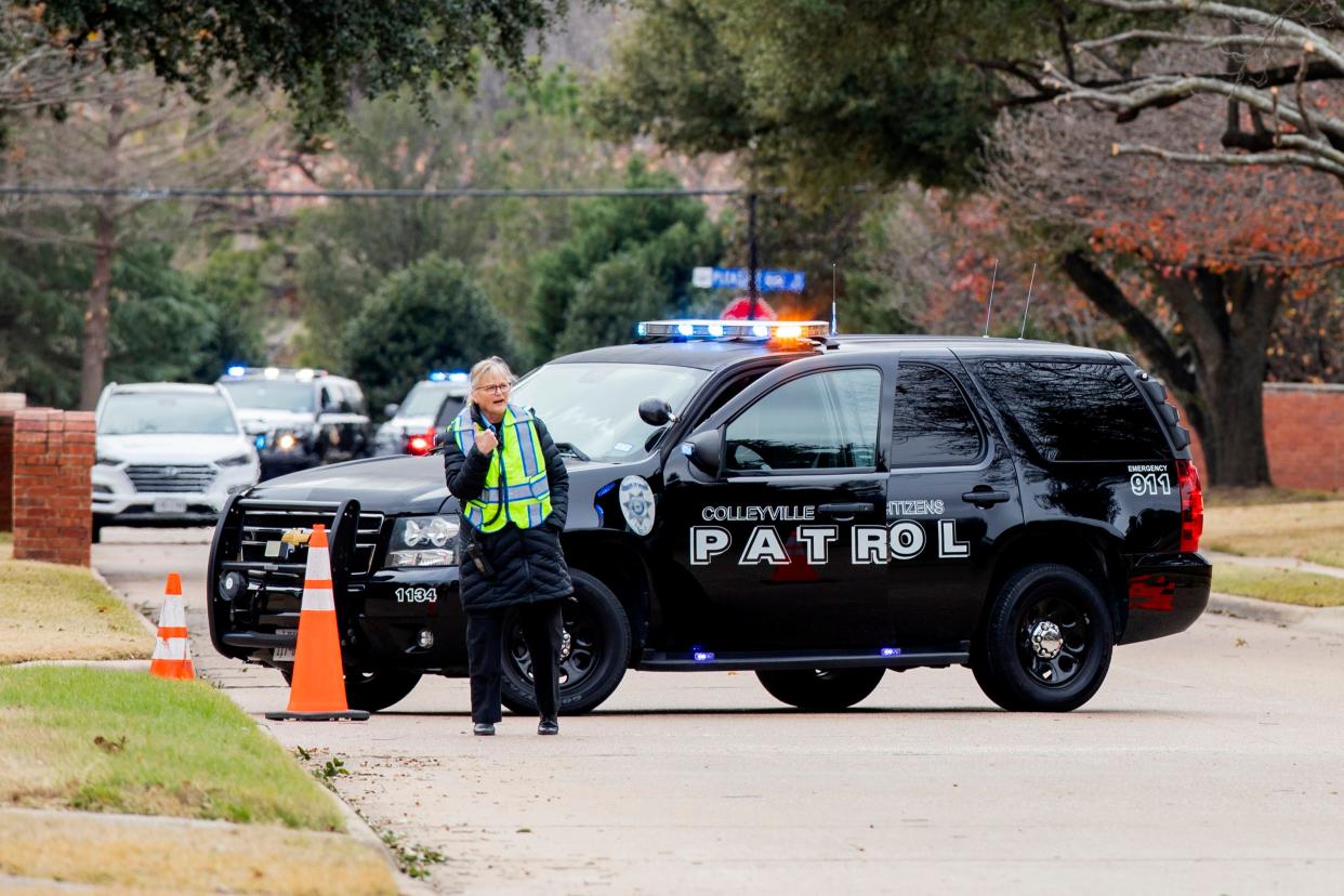 Law enforcement officials block a residential street near Congregation Beth Israel synagogue where a man took hostages during services on Jan. 15, 2022, in Colleyville, Texas.