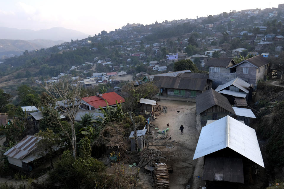 A girl walks in the courtyard of her house, just below the house of Shimray Wungreichon, 43, who works as a nurse in a government hospital in Ukhrul, in the northeastern Indian state of Manipur, Friday, Jan. 15, 2021. This little mountain town has a single 100-bedded government hospital that caters to 180,000 people of the entire district. (AP Photo/Yirmiyan Arthur)