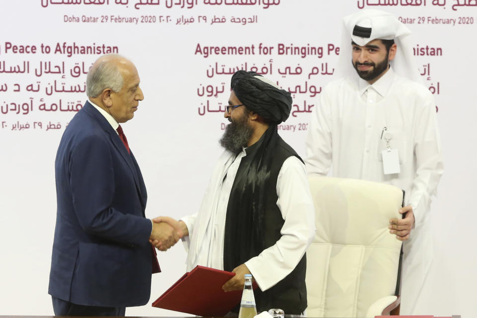 El enviado estadounidense Zalmay Khalilzad, izquierda, y el jefe político del Talibán, mulá Abdul Ghani Baradar, se estrechan la mano después de firmar el acuerdo de paz entre el Talibán y Estados Unidos en Doha, Qatar, sábado 29 de febrero de 2020. (AP Foto/Hussein Sayed)